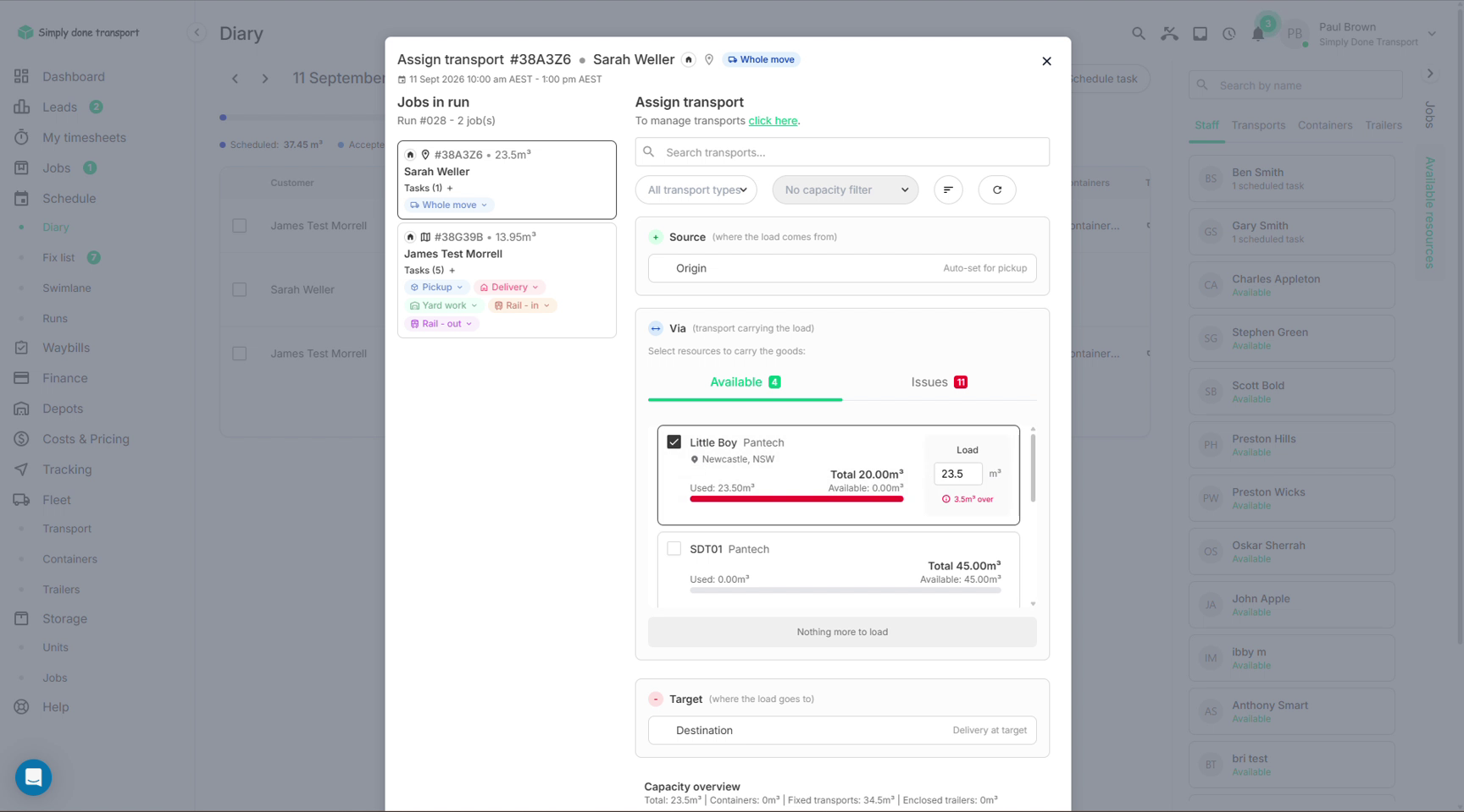 Assign transport dialog with two trucks selected, splitting the load